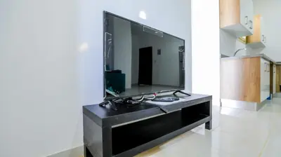 a large black entertainment center with a large screen tv at La bonita compound in Hurghada