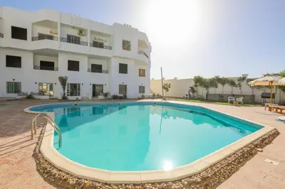 a large swimming pool in front of a building at La bonita compound in Hurghada