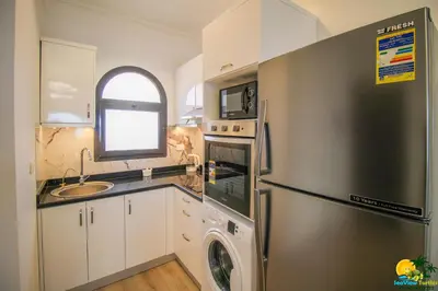a kitchen with a stainless steel refrigerator and a sink at Bellevue The View in Hurghada