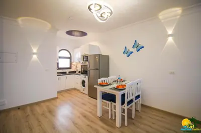 a kitchen with a table and chairs and a refrigerator at Bellevue The View in Hurghada