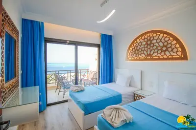 a hotel room with two beds and a balcony at Bellevue The View in Hurghada
