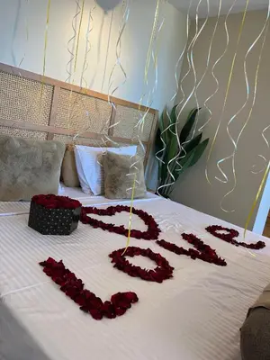 a bed with red roses spelled out on it at Suite 69 in Hurghada