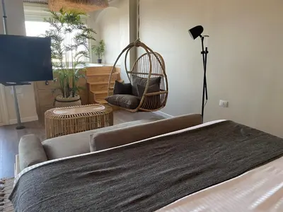 a room with a bed and a chair and a lamp at Suite 69 in Hurghada