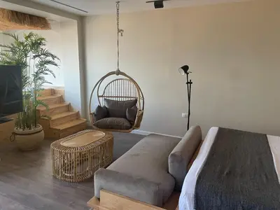 a living room with a couch and a swing at Suite 69 in Hurghada