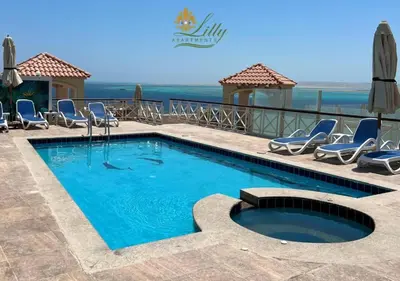 a swimming pool with lounge chairs and a swimming pool at Suite 69 in Hurghada