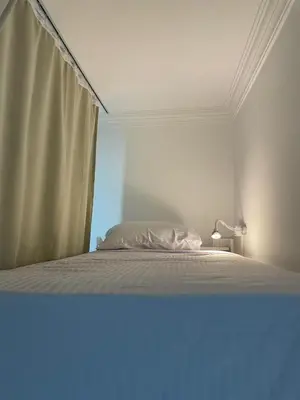a white bed in a room with a window at Serafy City Center Hostel for Foreigners Adults Only in Hurghada