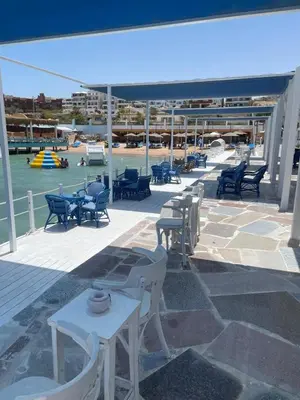 a group of tables and chairs on a patio at Lilly Stays Sheraton Road in Hurghada