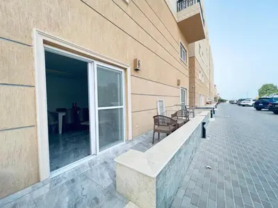 a building with benches on the side of a street at Selina Apartments in Hurghada