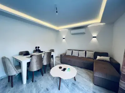 a living room with a couch and a table and chairs at Selina Apartments in Hurghada