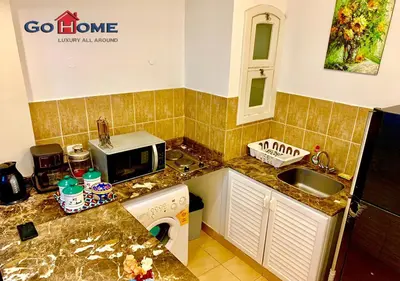 a small kitchen with a sink and a microwave at 1 Bed Room West Golf at El-Gouna Y12-0 in Hurghada