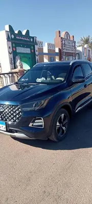 a black car parked in a parking lot at Kamel House in Aswan
