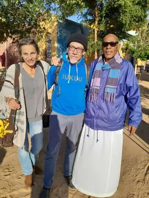a group of three people standing next to each other at Kamel House in Aswan