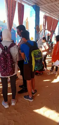 a group of people standing around in a tent at Kamel House in Aswan