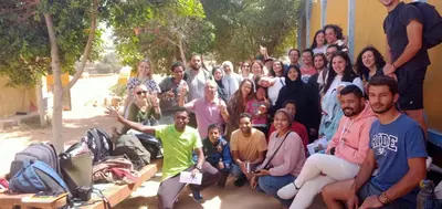 a group of people are posing for a picture at Kamel House in Aswan