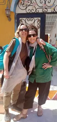 two women standing next to each other in front of a building at Kamel House in Aswan