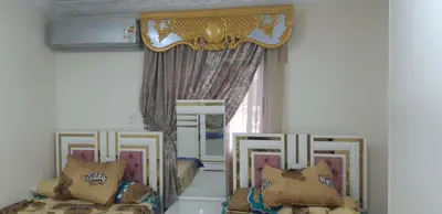 a room with two beds and a window at Aswan Nile view palace in Naj‘ al ‘Amrāb