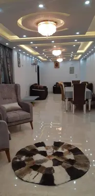 a lobby with couches and a rug on the floor at Aswan Nile view palace in Naj‘ al ‘Amrāb