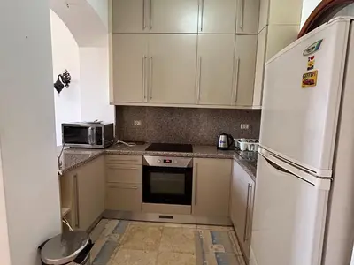 a kitchen with white cabinets and a white refrigerator at Hurghada Concierge in EL-Gouna in Hurghada