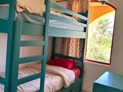 a green bunk bed in a room with a window at Hurghada Concierge in EL-Gouna in Hurghada