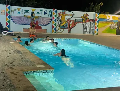a group of people swimming in a swimming pool at Luxor Nile View Flats in Luxor