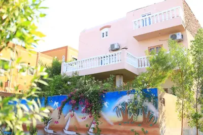 a building with a painting on the side of it at Luxor Nile View Flats in Luxor