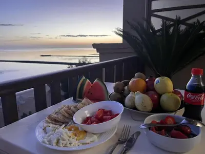 a plate of food on a table with a view of the ocean at Apartment - Sleeps 4 - Pool - Pet friendly in Hurghada