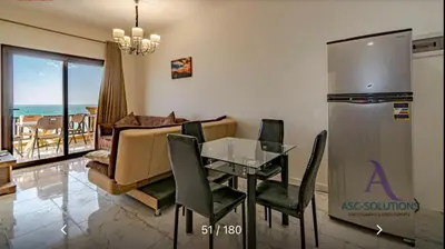a living room with a table and a couch at Apartment - Sleeps 4 - Pool - Pet friendly in Hurghada