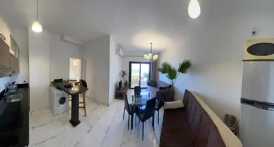a kitchen and dining room with a table and a dining room at Apartment - Sleeps 4 - Pool - Pet friendly in Hurghada