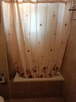 a shower with a shower curtain in a bathroom at Sunset pearl sahl hasheesh in Hurghada