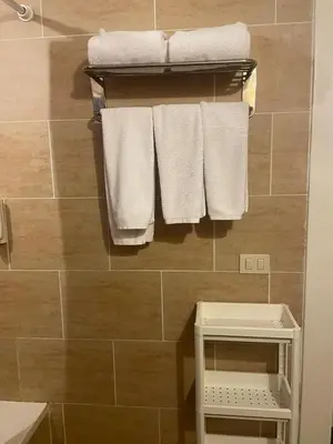 a bathroom with white towels hanging on a wall at Sunset pearl sahl hasheesh in Hurghada