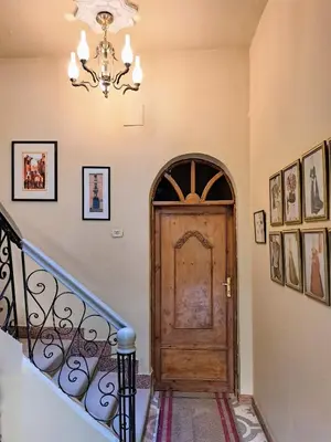 a staircase with a wooden door and a chandelier at Villa Belzoni in Luxor