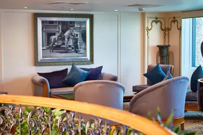 a living room with chairs and a couch and a picture at Sonesta St George Nile Cruise - Luxor to Aswan 4 Nights from Monday to Friday in Luxor