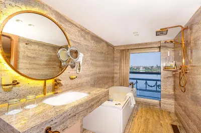 a bathroom with a sink and a mirror at Sonesta St George Nile Cruise - Luxor to Aswan 4 Nights from Monday to Friday in Luxor