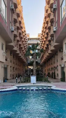 a swimming pool in the middle of a building at Casablanca Beach Direct sea view Tow Bedroom Apartment in Hurghada