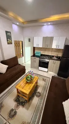 a living room with a couch and a coffee table at Casablanca Beach Direct sea view Tow Bedroom Apartment in Hurghada