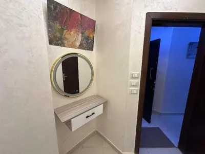 a bathroom with a mirror on a wall at Casablanca Beach Direct sea view Tow Bedroom Apartment in Hurghada