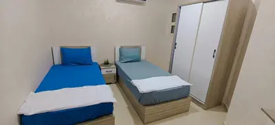 two beds in a room with blue and white at Casablanca Beach Direct sea view Tow Bedroom Apartment in Hurghada