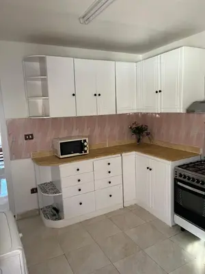 a kitchen with white cabinets and a microwave at Villa Touristic Village Nr 7030 in Hurghada