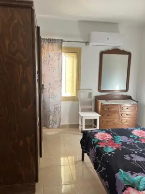 a bedroom with a bed and a dresser and a mirror at Villa Touristic Village Nr 7030 in Hurghada
