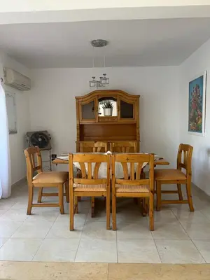 a dining room with a table and a piano at Villa Touristic Village Nr 7030 in Hurghada