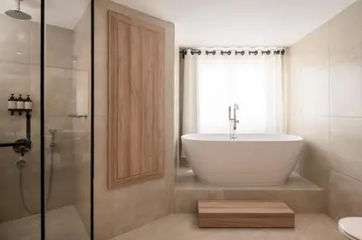 a bathroom with a tub and a shower and a sink at Serry Beach Resort in Hurghada