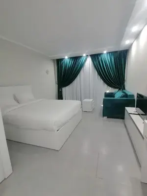 a white room with a bed and a couch at Scandic Resort in Hurghada