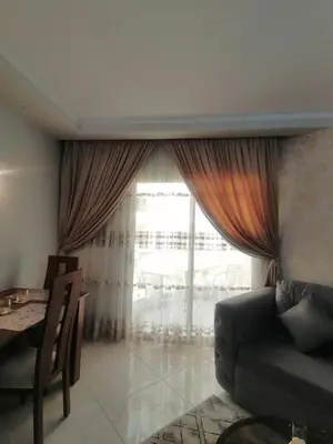 a living room with a couch and a table and a window at Scandic Resort in Hurghada