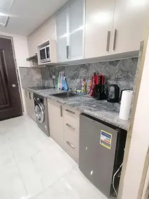 a kitchen with a sink and a washing machine at Scandic Resort in Hurghada