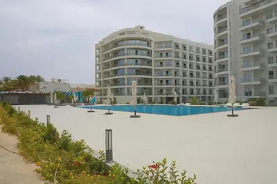 a large building with a swimming pool in front of it at Scandic Resort in Hurghada, EGYPT in Hurghada
