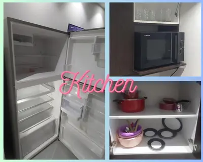 a refrigerator with its door open and a microwave at Scandic Resort: Comfy & Cozy. A433 in Hurghada