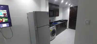 a kitchen with a refrigerator and a washing machine at Scandic Resort: Comfy & Cozy. A433 in Hurghada