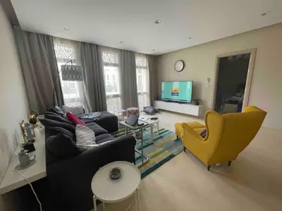 a living room with a couch and a yellow chair at Mangroovy Tasteful 1 bedroom in Hurghada
