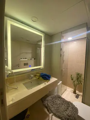 a bathroom with a sink and a mirror and a shower at Mangroovy Tasteful 1 bedroom in Hurghada