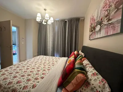 a bedroom with a bed with a blanket on it at Mangroovy Tasteful 1 bedroom in Hurghada